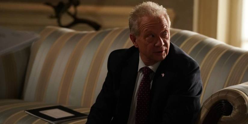 Thatcher Grey sitting on a couch on Grey's Anatomy