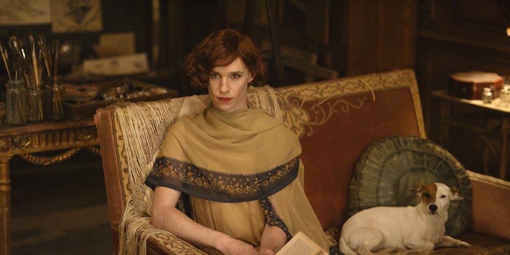 Lili sits on couch in The Danish Girl