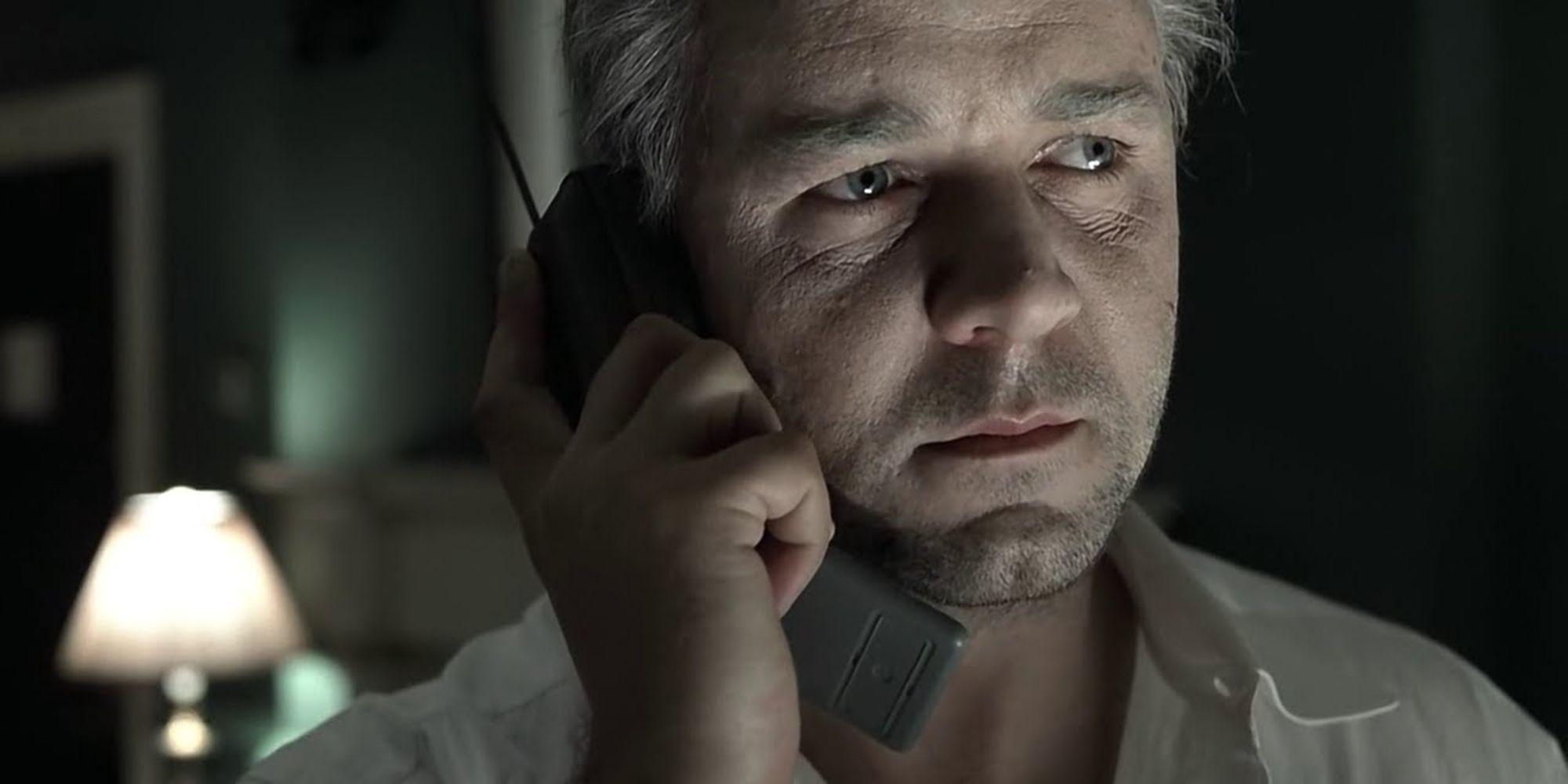 Russell Crowe with cellphone against his face in The Insider