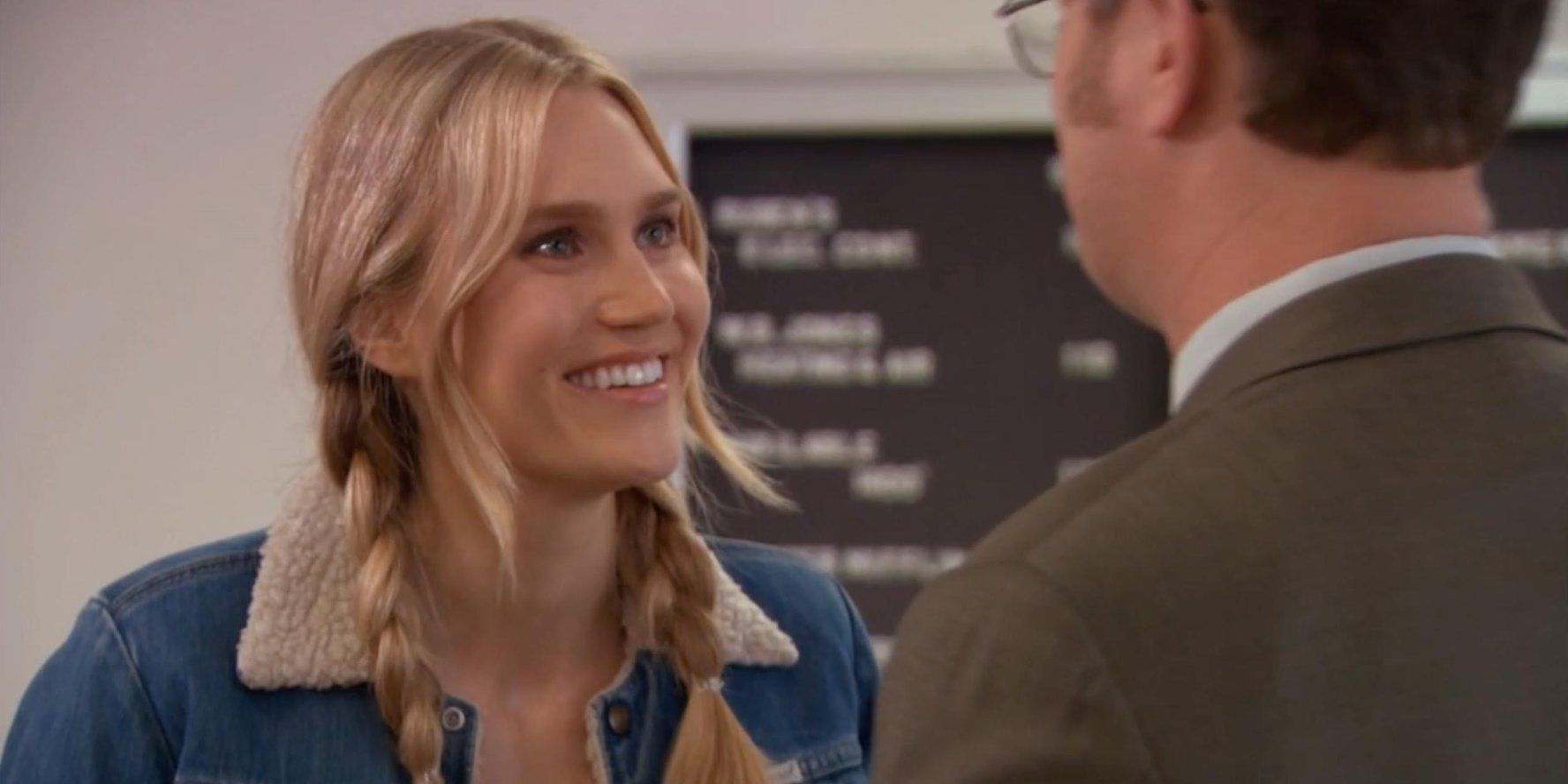 Esther in jean jacket, smiling at Dwight
