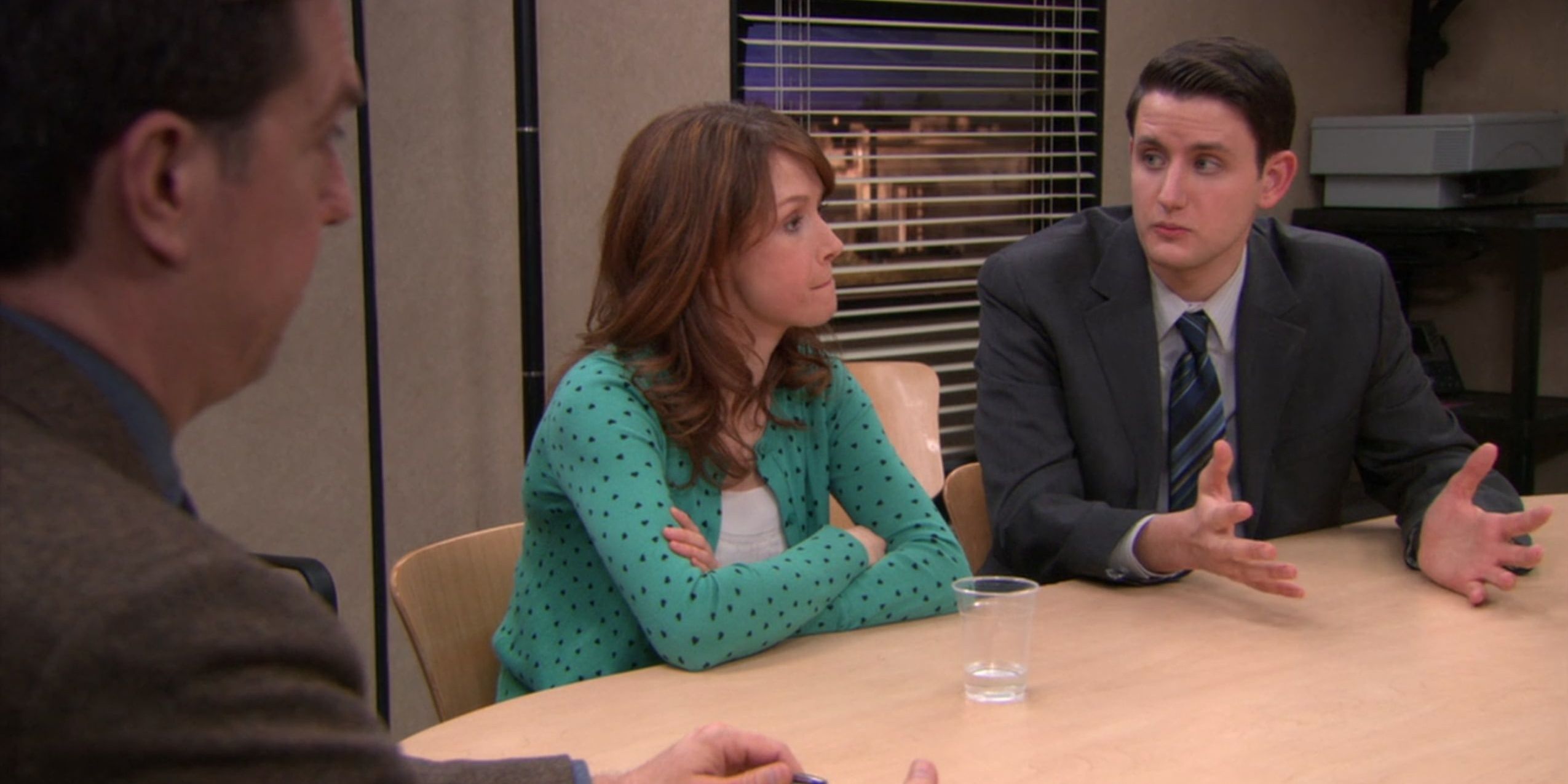 Andy, Erin and Gabe sitting at conference room table. Erin looks annoyed as Gabe explains something.