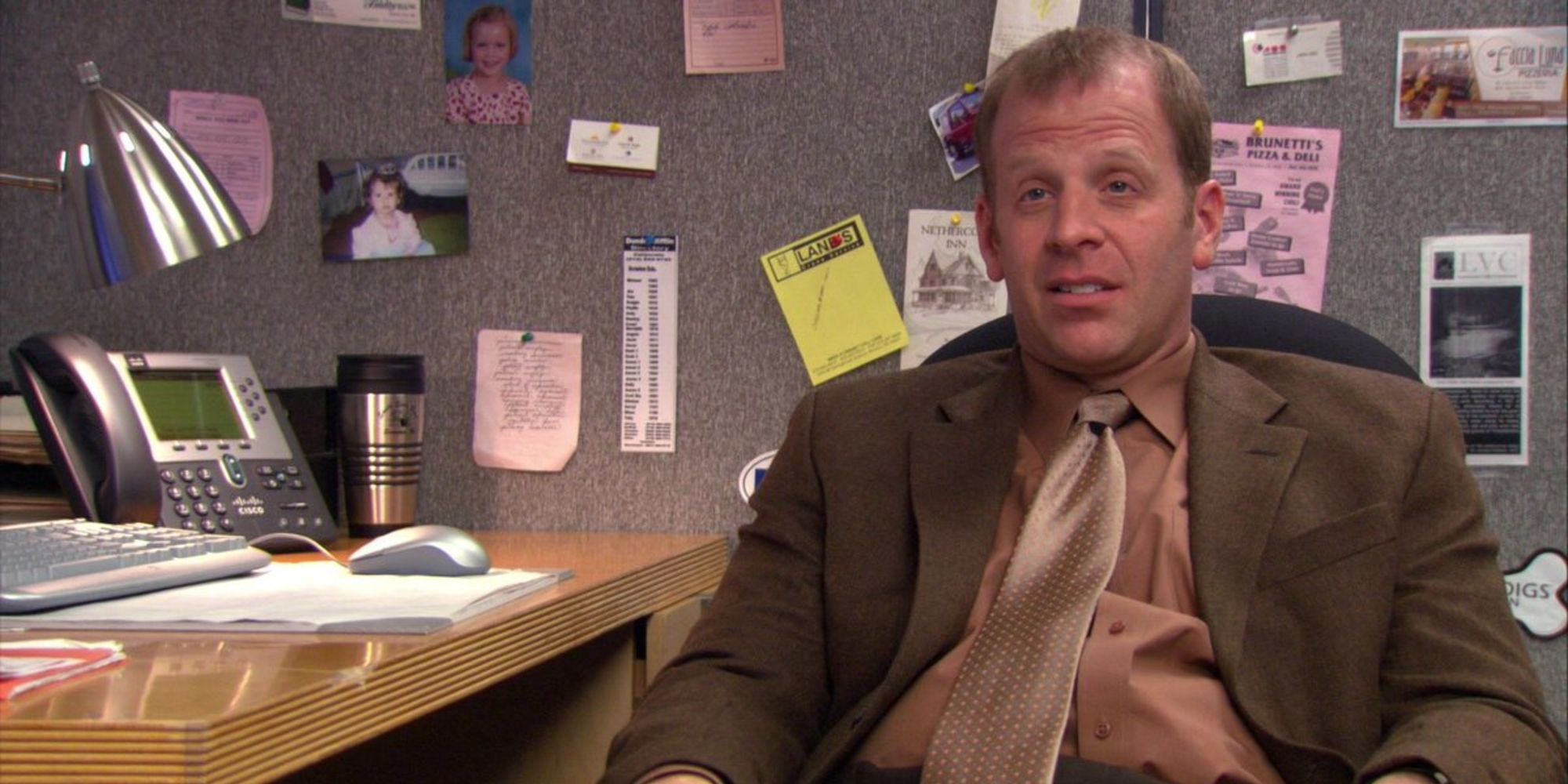 Toby Flenderson (Paul Lieberstein) sits at his desk in The Office