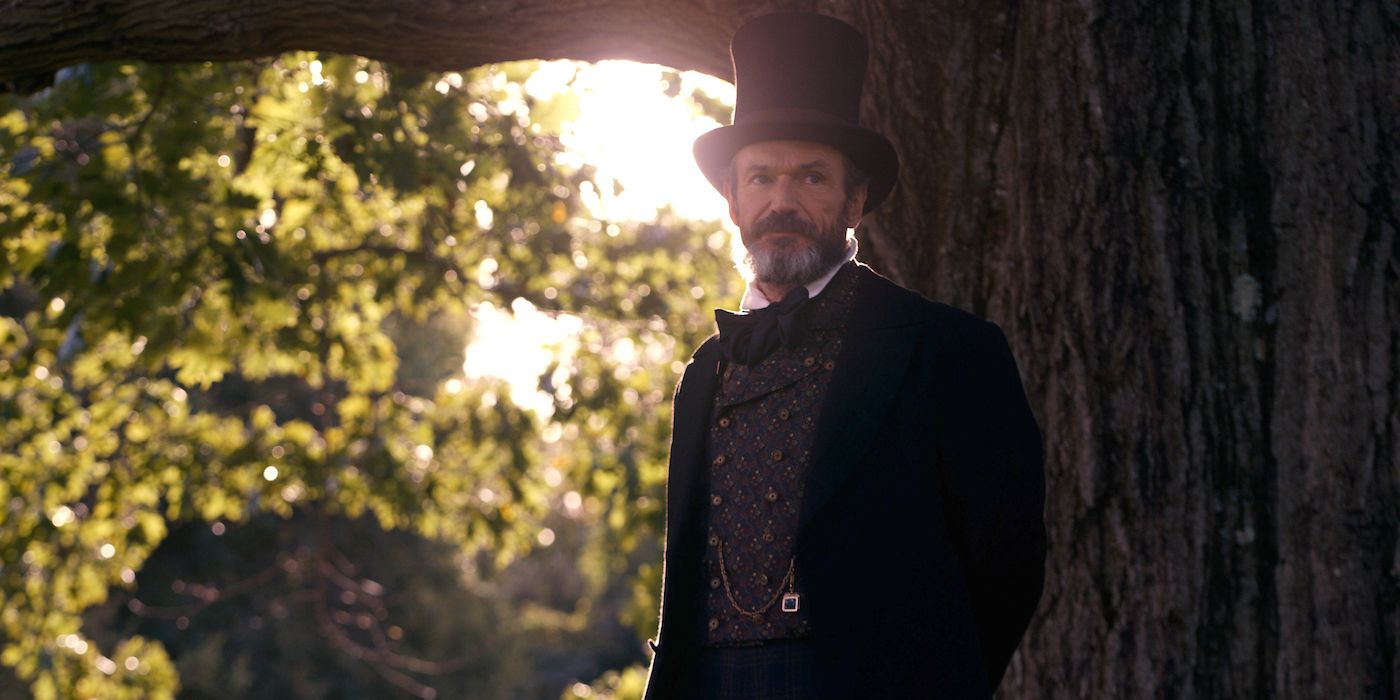 Toby Huss as Edward standing in front of a tree in Dickinson