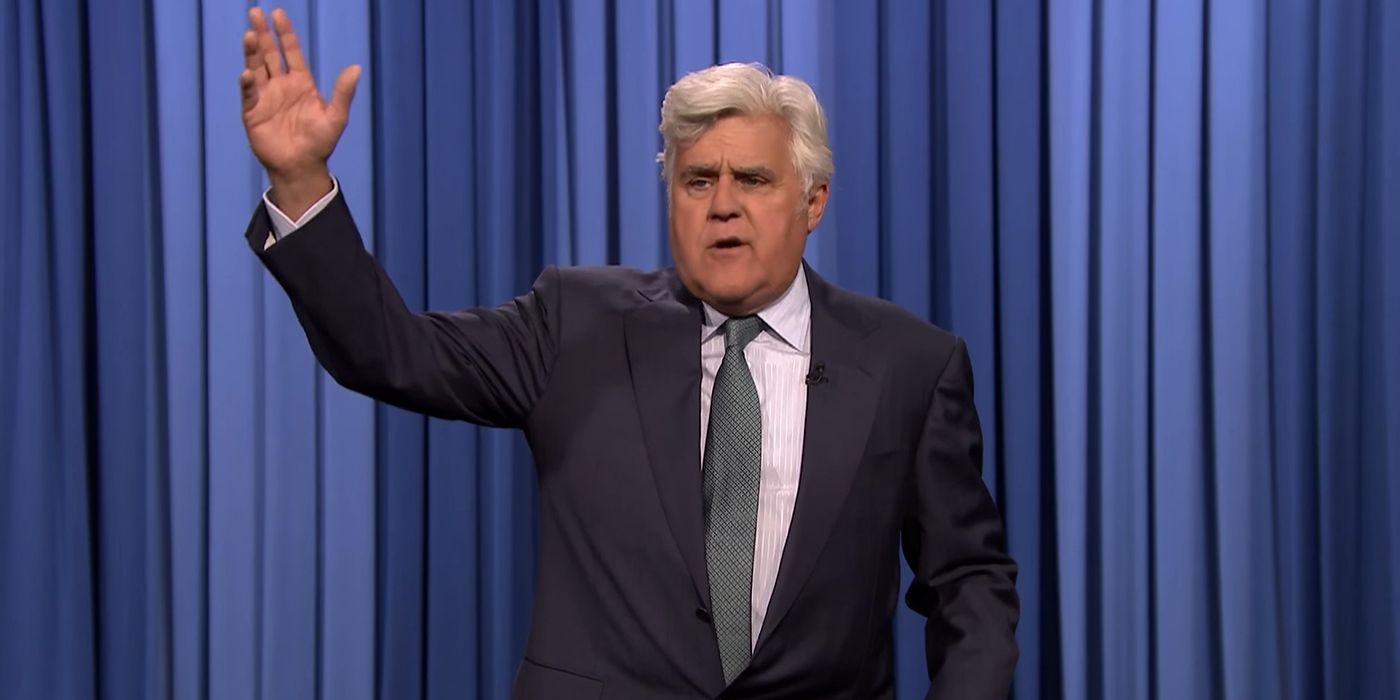 Jay Leno with his hand raised on The Tonight Show