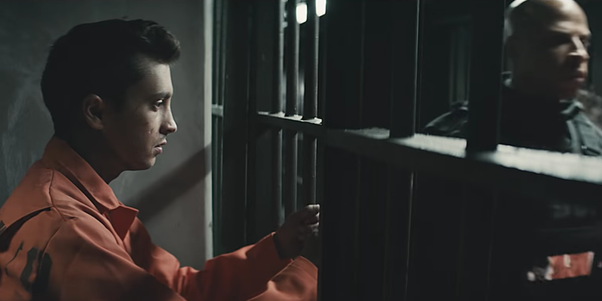 Tyler Joseph behind bars in a still from the Heathens music video