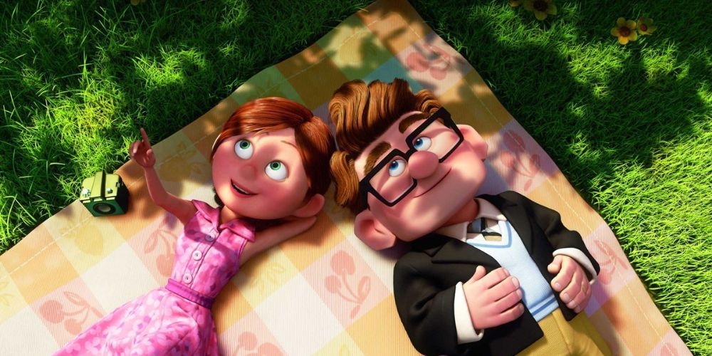Young Russell and Ellie laying outside together on a blanket in Up