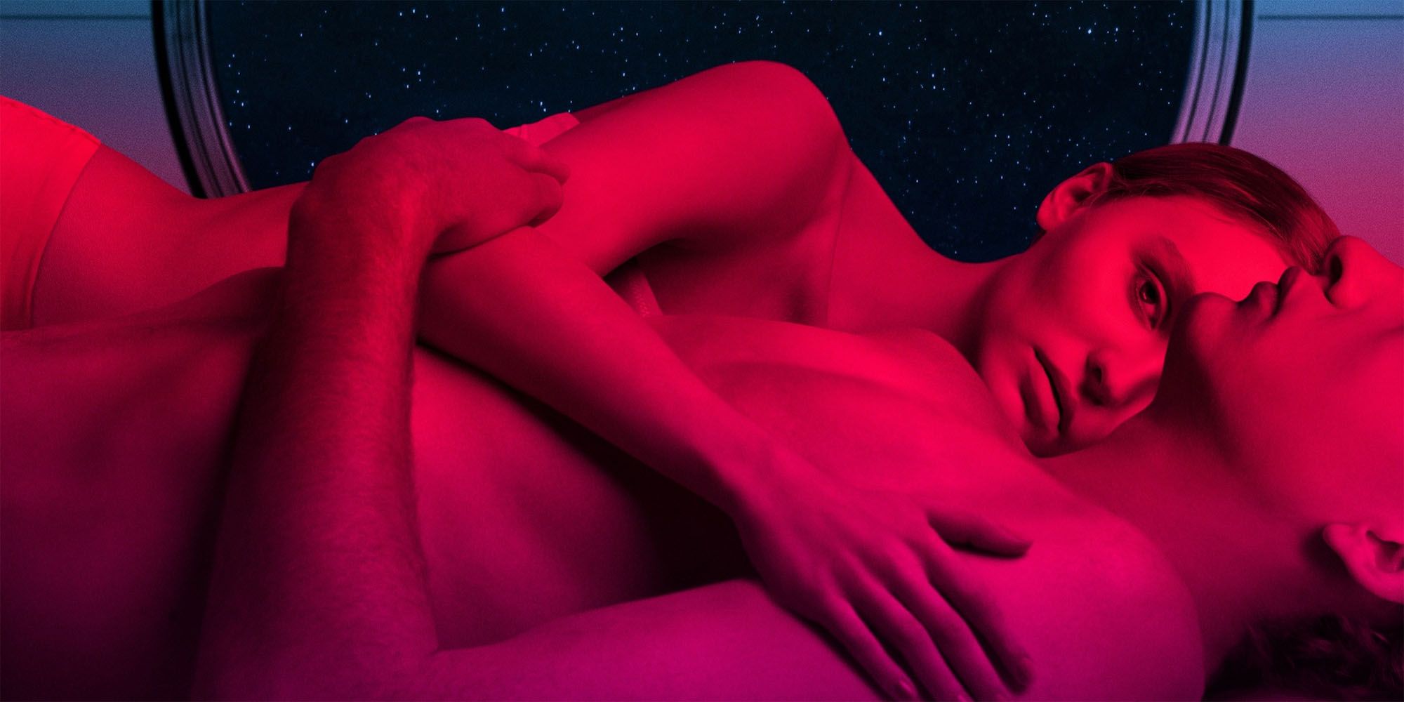 A man and woman lay together in neon light from the Voyagers poster.