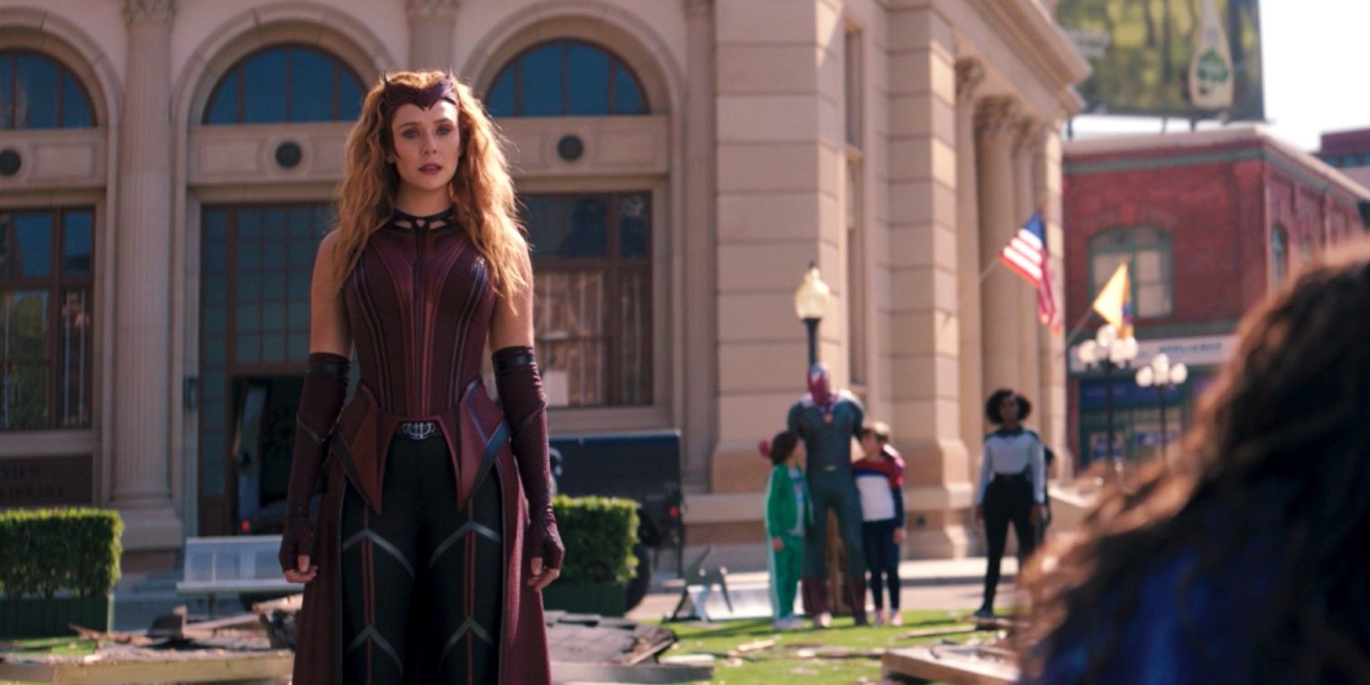 Wanda in her Scarlet Witch costume standing in Westview in WandaVision