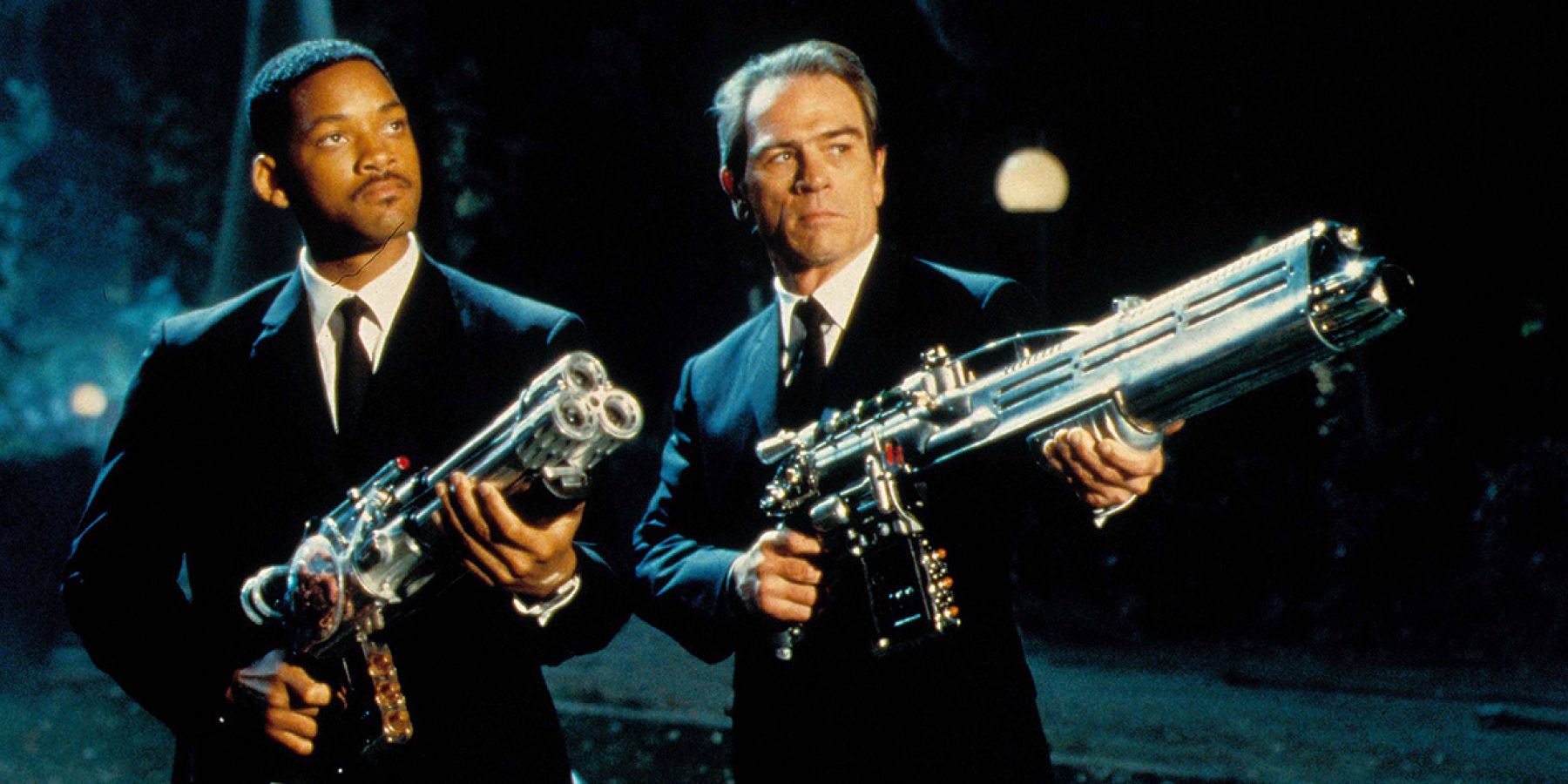 Agents J and K pointing huge guns at the end of Men in Black