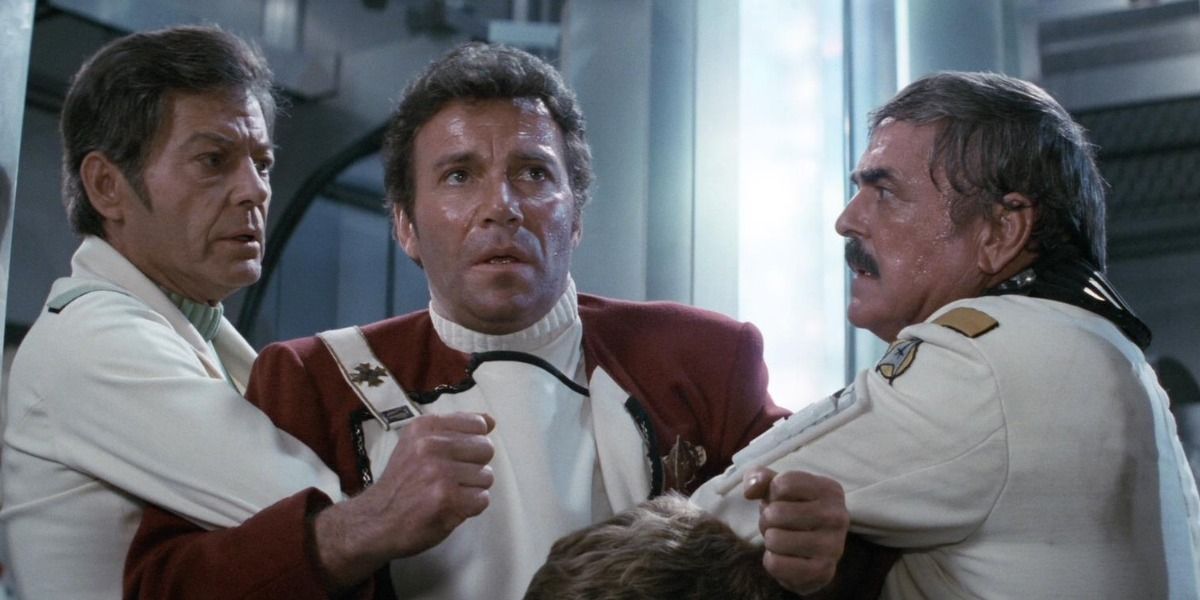 Bones and Scotty hold Kirk back from Star Trek II The Wrath of Khan