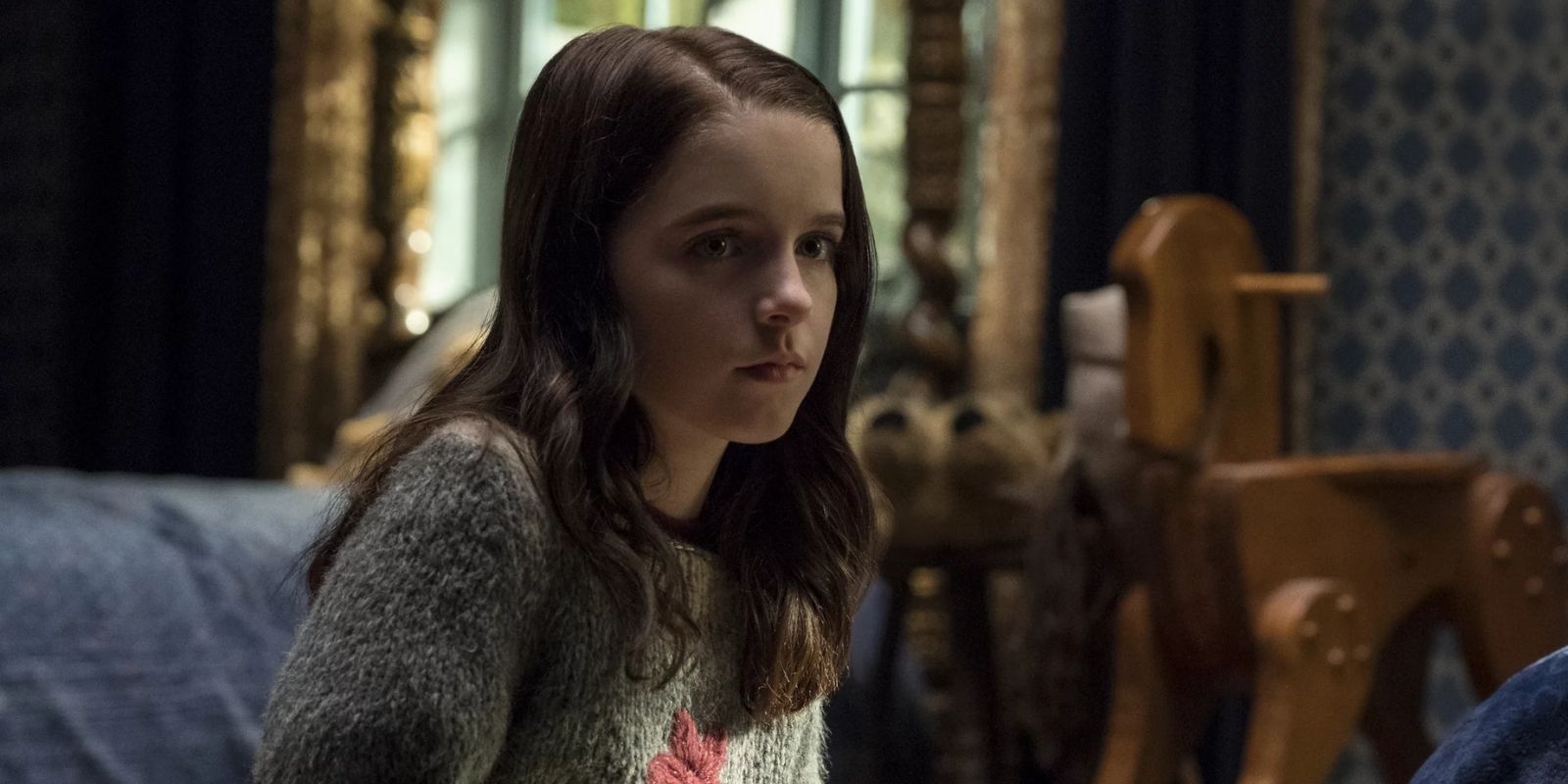 Young Theo Crain sits in her bedroom in The Haunting of Hill House