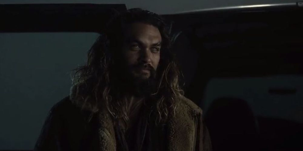 Aquaman stands by the van and looks ahead