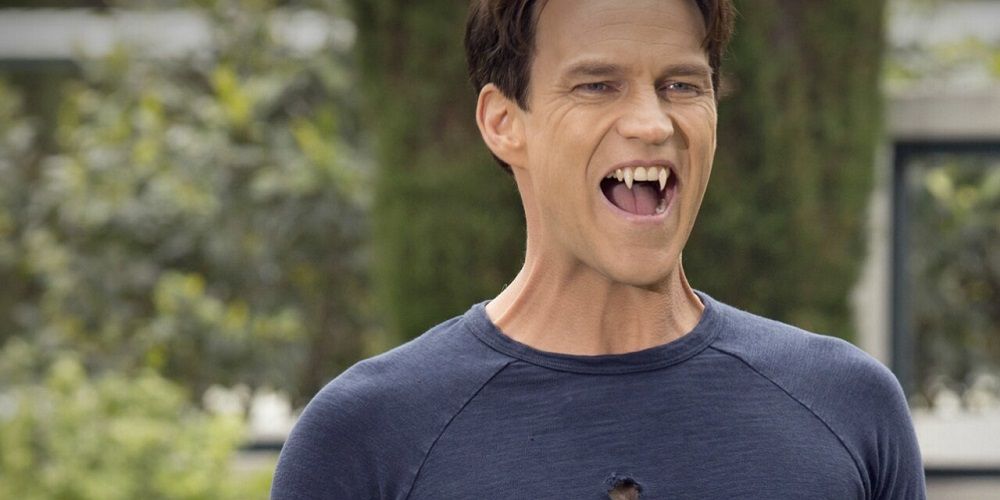 Bill flashes fangs in holy shirt in True Blood