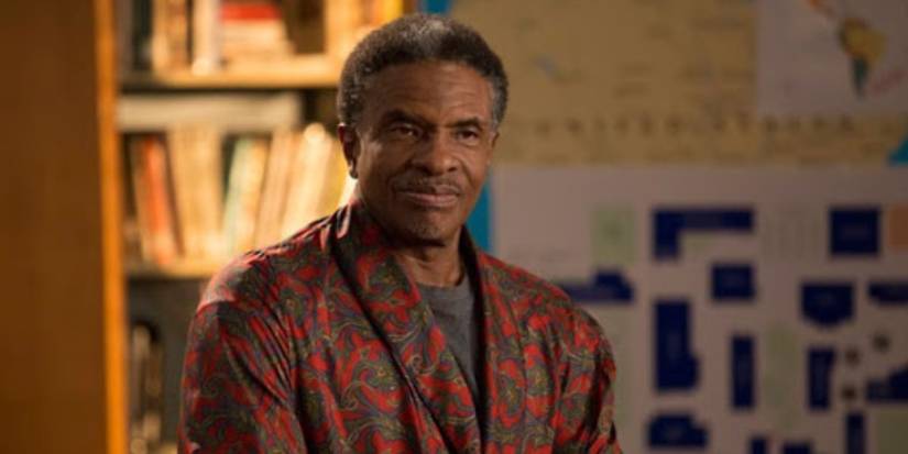 Elroy standing in the study room in Community.