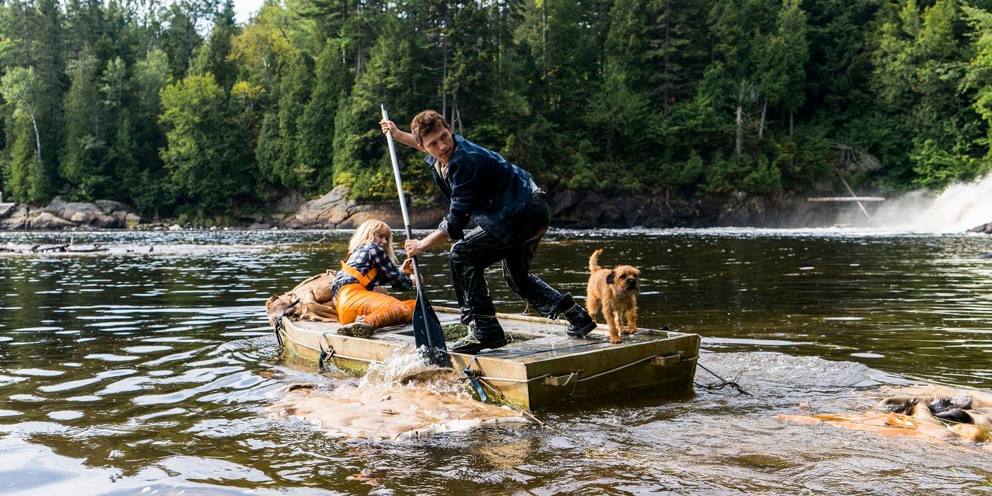 Tom Holland and Daisy Ridley sitting on a raft in Chaos Walking