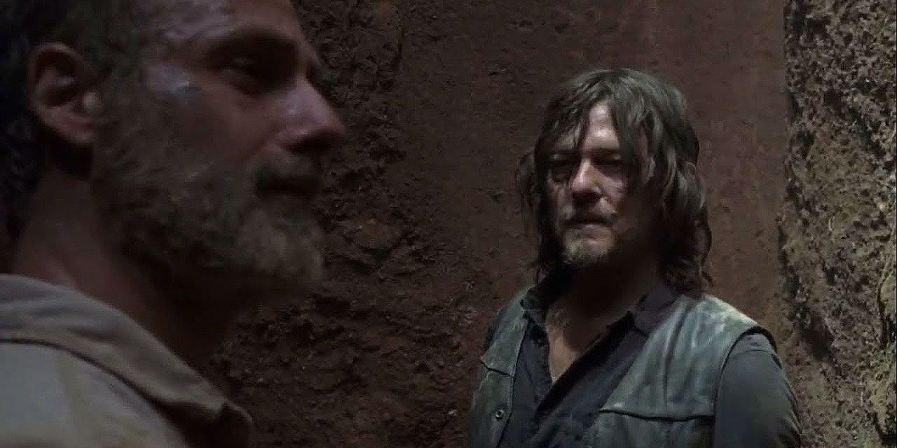 daryl looks at rick while they're in a ditch 