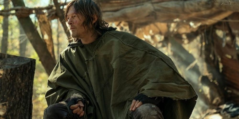 daryl wears a makeshift coat in the woods 