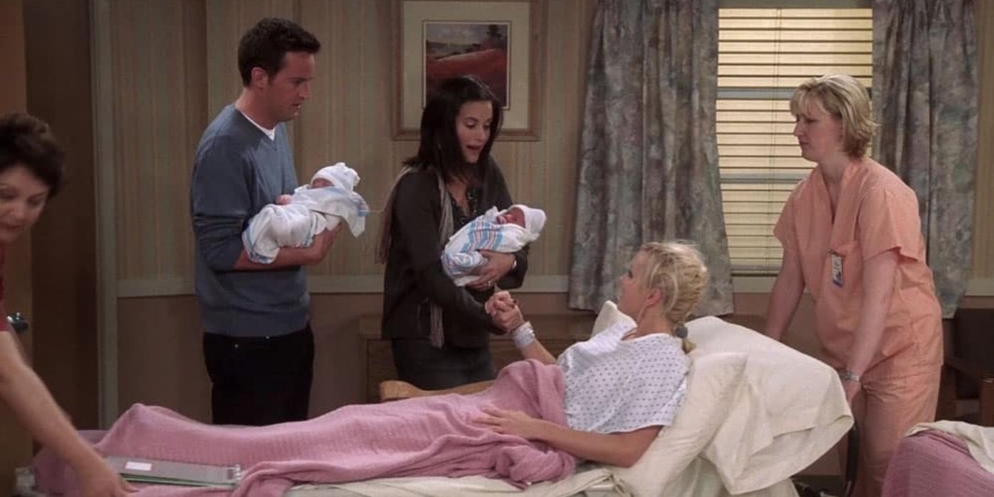 Monica and Chandler hold their twins while standing next to the babies' birth mother.