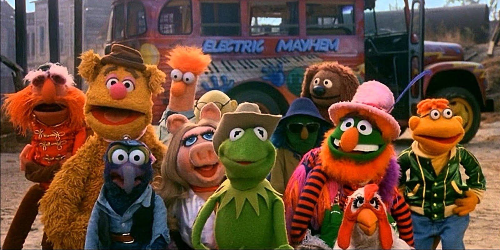 Still from The Muppet Movie with characters such as Kermit, Miss Piggy, Gonzo, Fozzie, Camilla, Animal, and more-Electric Mayhem travel bus in background