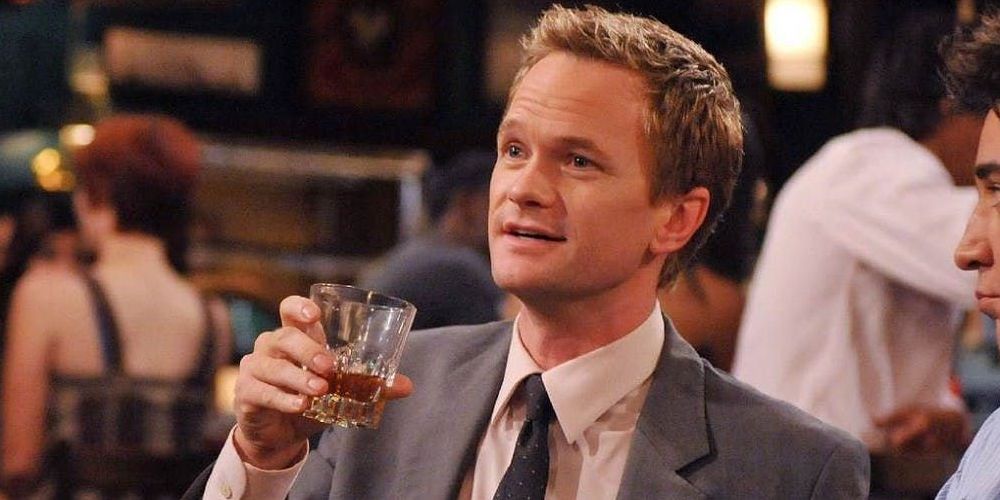 Neil Patrick Harris holding a drink and elucidating in HIMYM