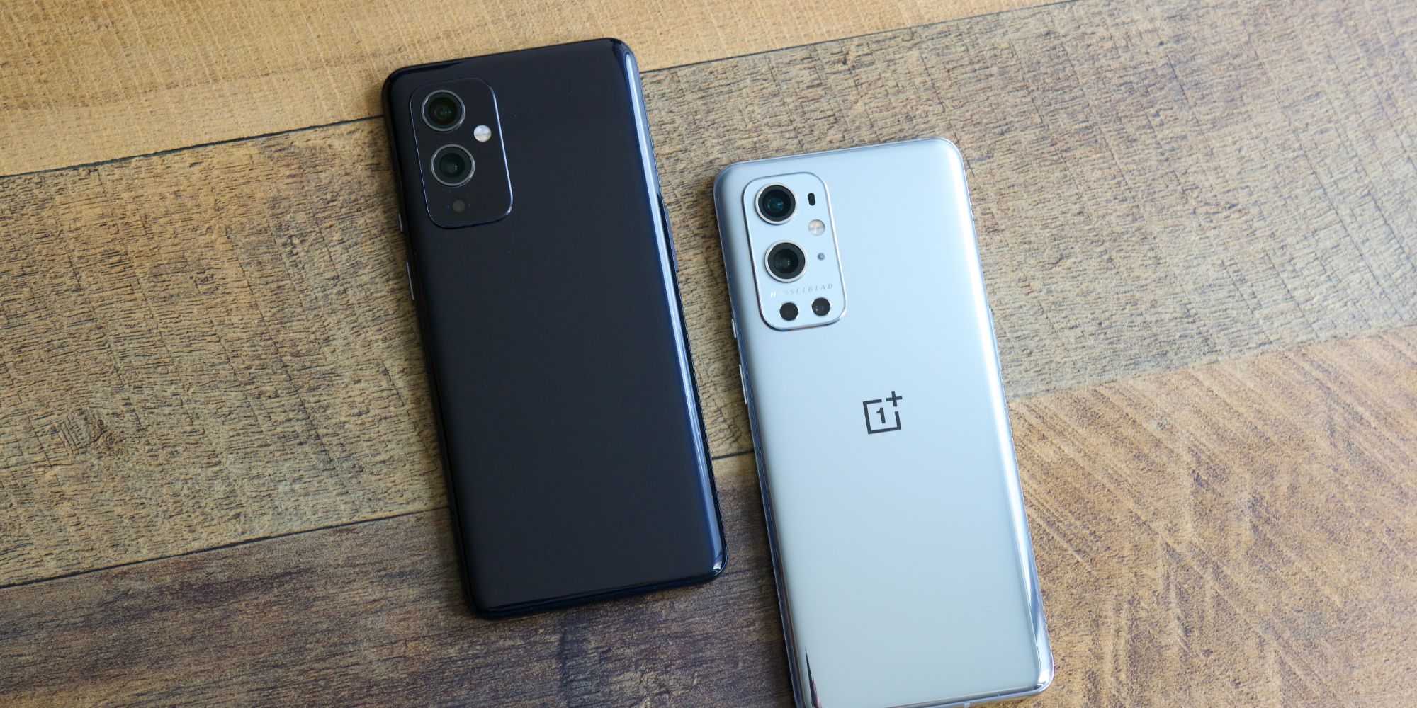 OnePlus 9 and 9 Pro on a wood table