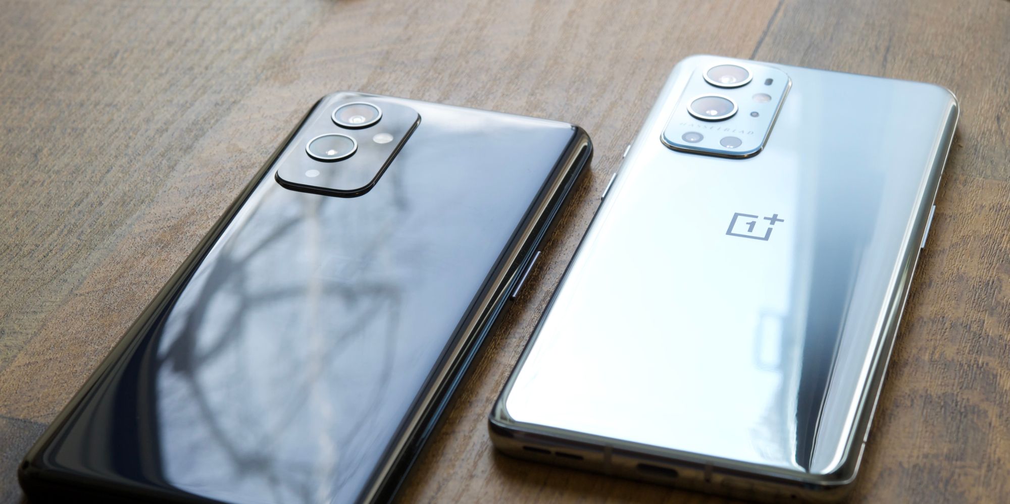 OnePlus 9 and 9 Pro on a wood table