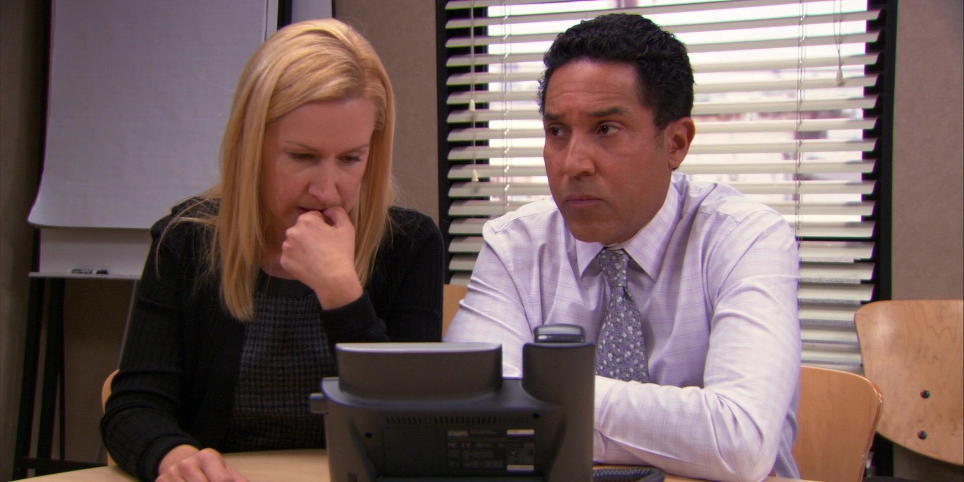 Oscar and Angela talking on the phone on The Office.