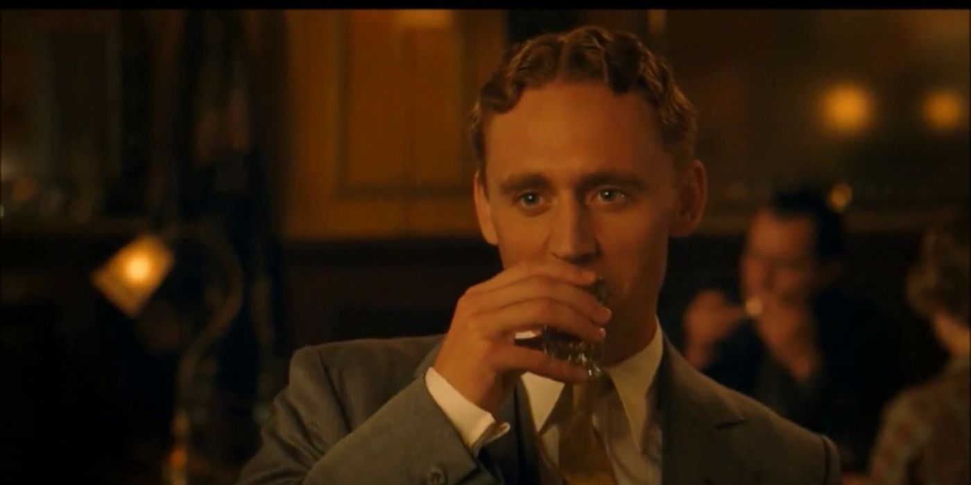 Tom Hiddleston taking a drink in Midnight in Paris