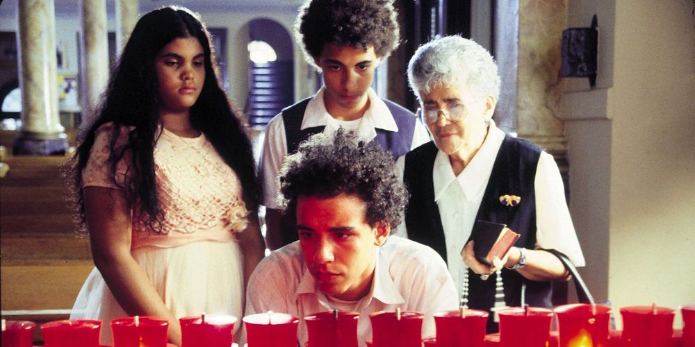 Victor and his family stare at candles in Raising Vicor Vargas
