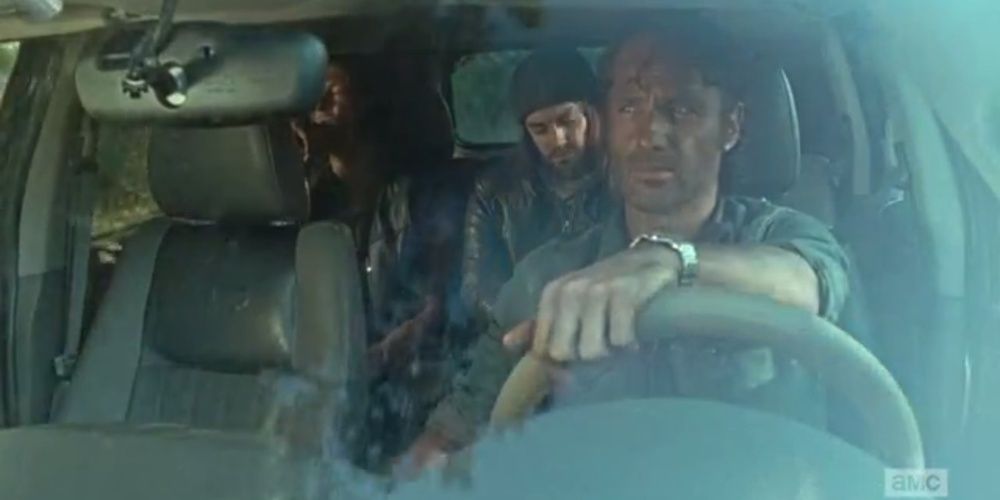 rick looks at daryl and jesus in the backseat of the car