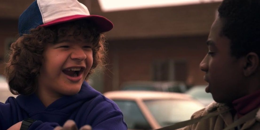 Dustin from Stranger Things shows off his new teeth to Lucas
