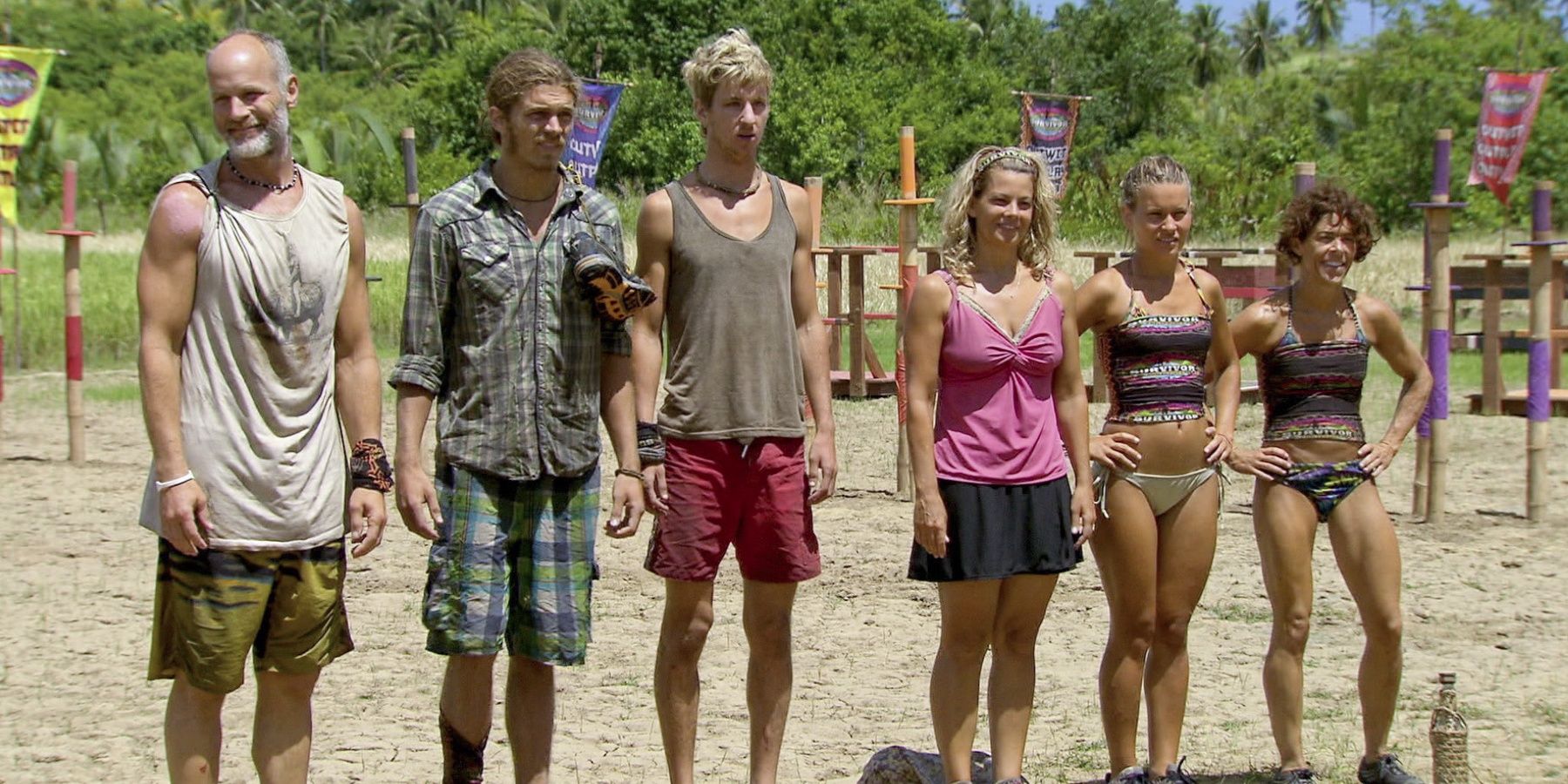 Survivor contestants stand in the sand