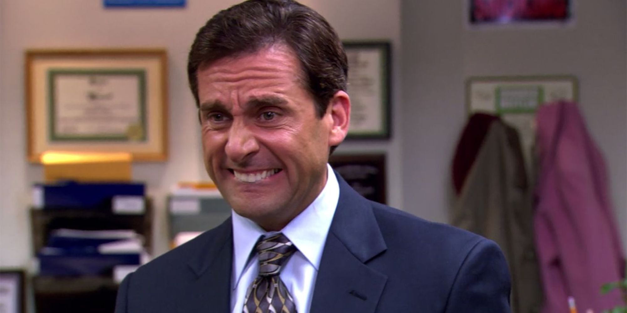 Michael Scott with an awkward smile in The Office