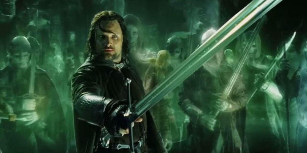 Aragorn holding his sword out surrounded by spirits in Lord of the Rings. 