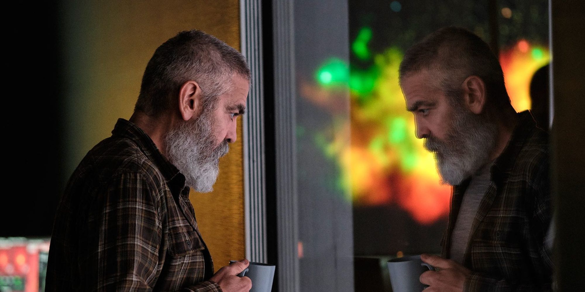 George Clooney looks into a mirror in The Midnight Sky