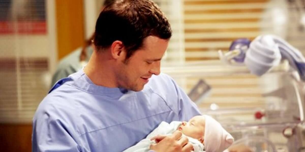 Alex holding a baby in NICU on Grey's Anatomy.