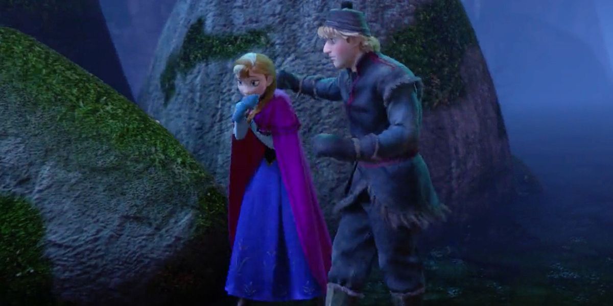 Kristoff putting his arms around Anna's shoulders as she shivers in Frozen