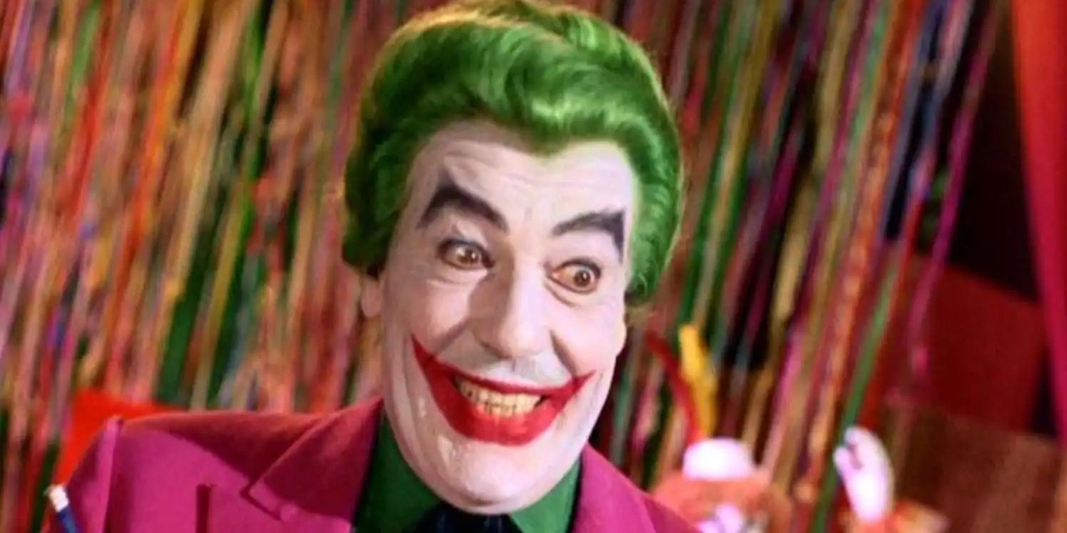 Cesar Romero's Joker smiling to someone off-camera in the 1966 Batman movie