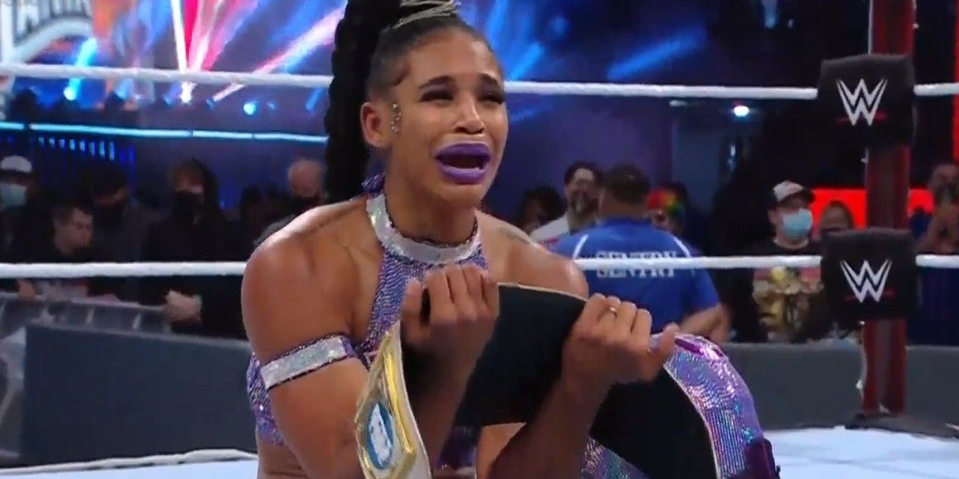Bianca Belair holding a WWE belt at Wrestlemania