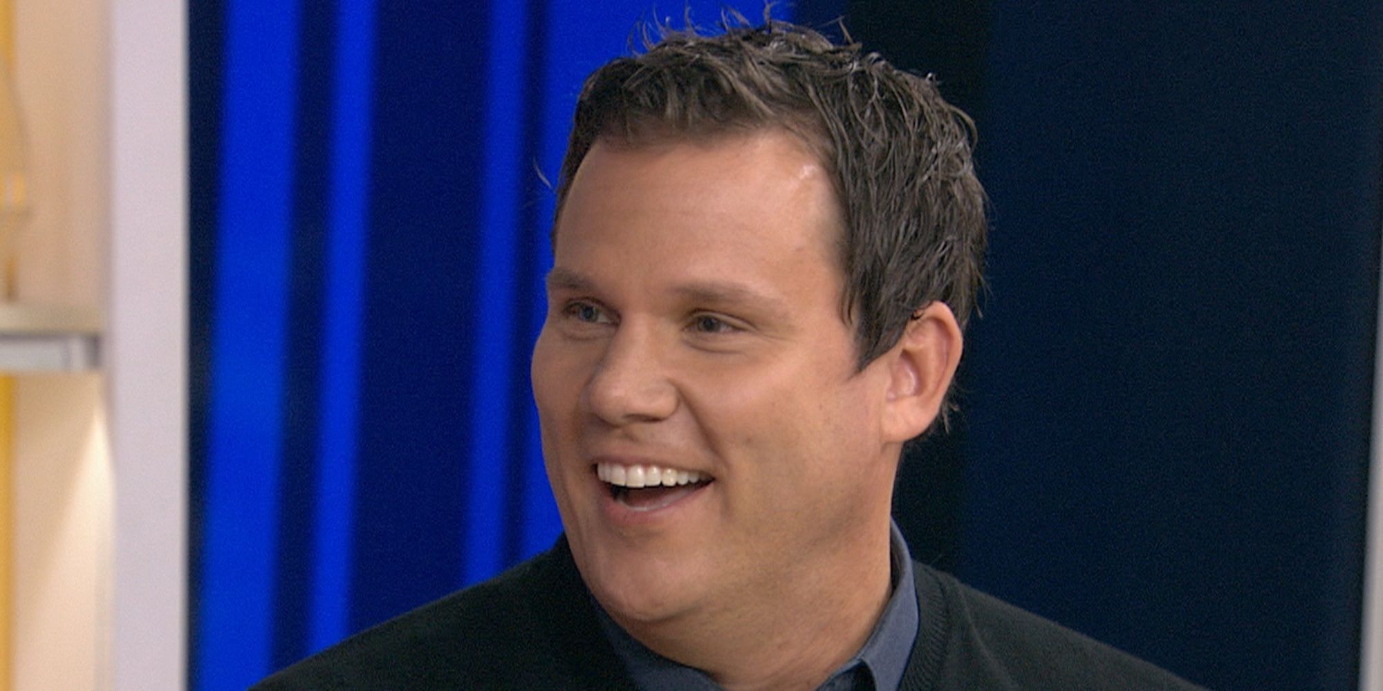 Bob Guiney smiles at someone off screen