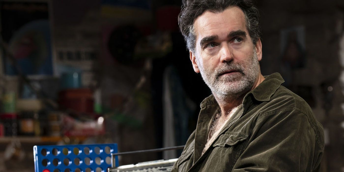 Brian d'Arcy James sitting at a table in Ferryman.