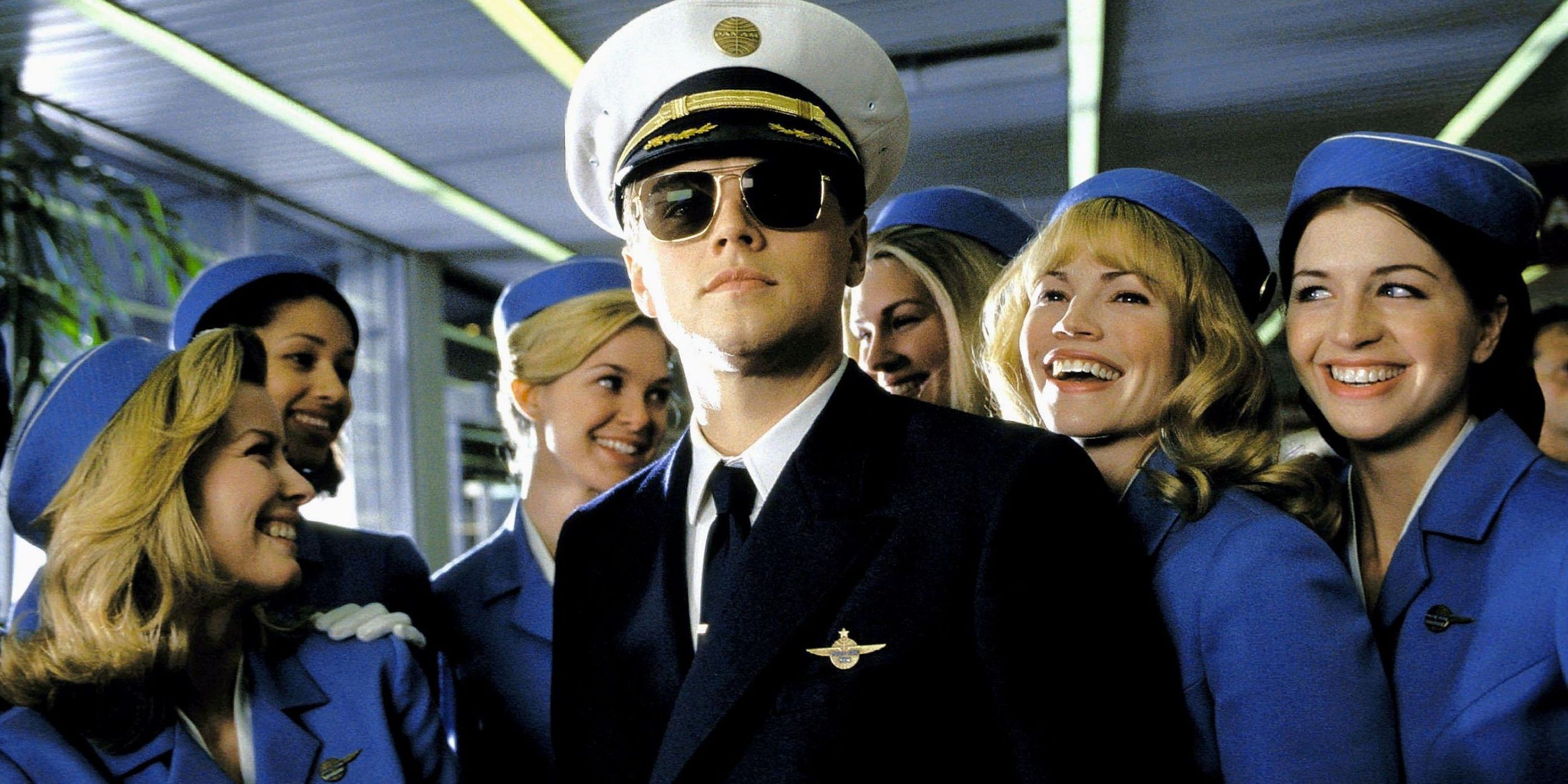 Frank Abagnale in pilot uniform with flight attendants in Catch Me If You Can.