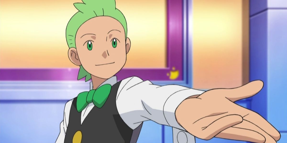 Cilan with his left hand extended and a smile on his face