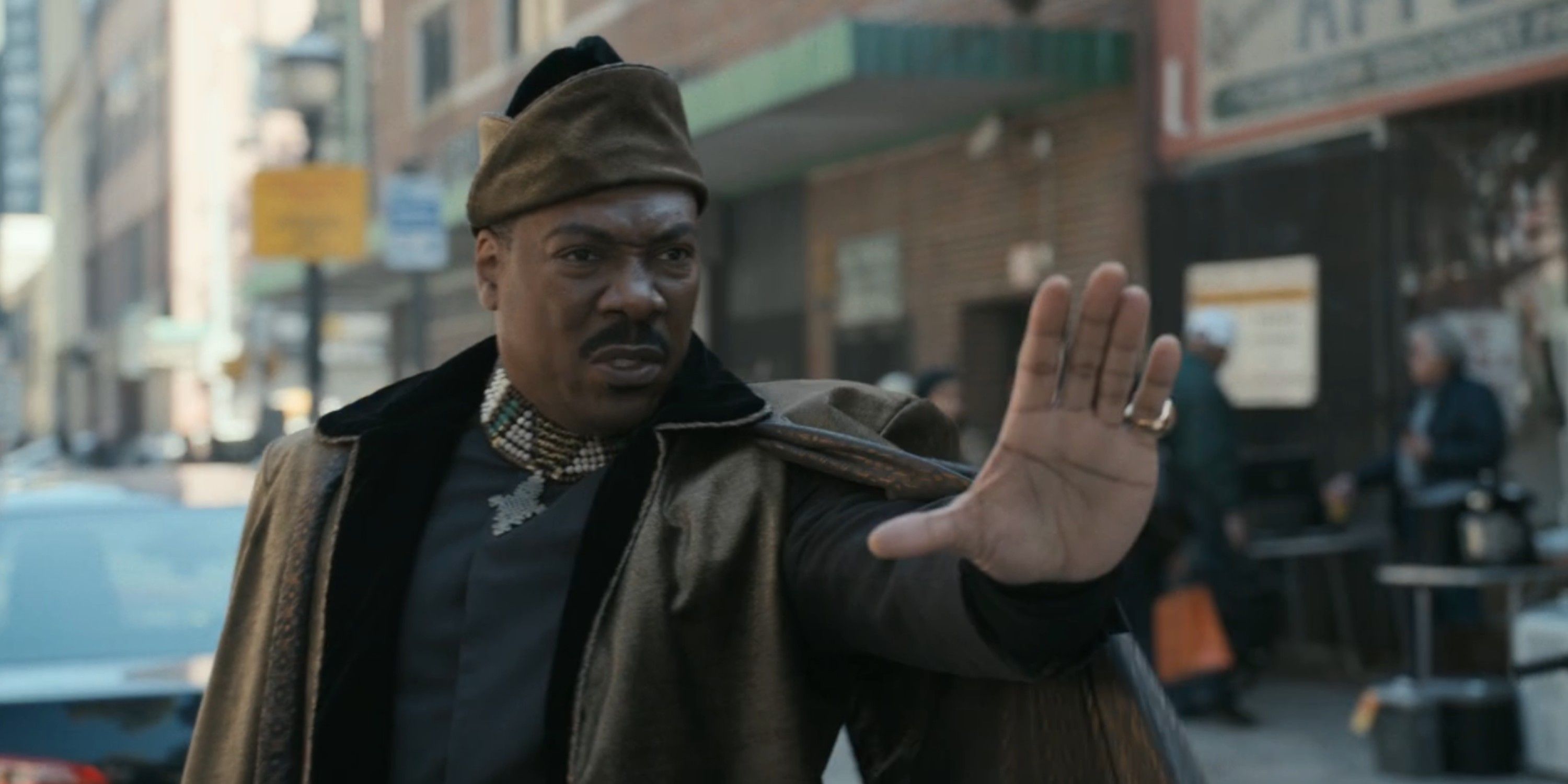 King Akeem Joffer stands in front of traffic in Coming 2 America on Amazon Prime