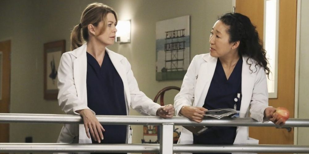 Cristina and Meredith standing on the balcony in Grey's Anatomy