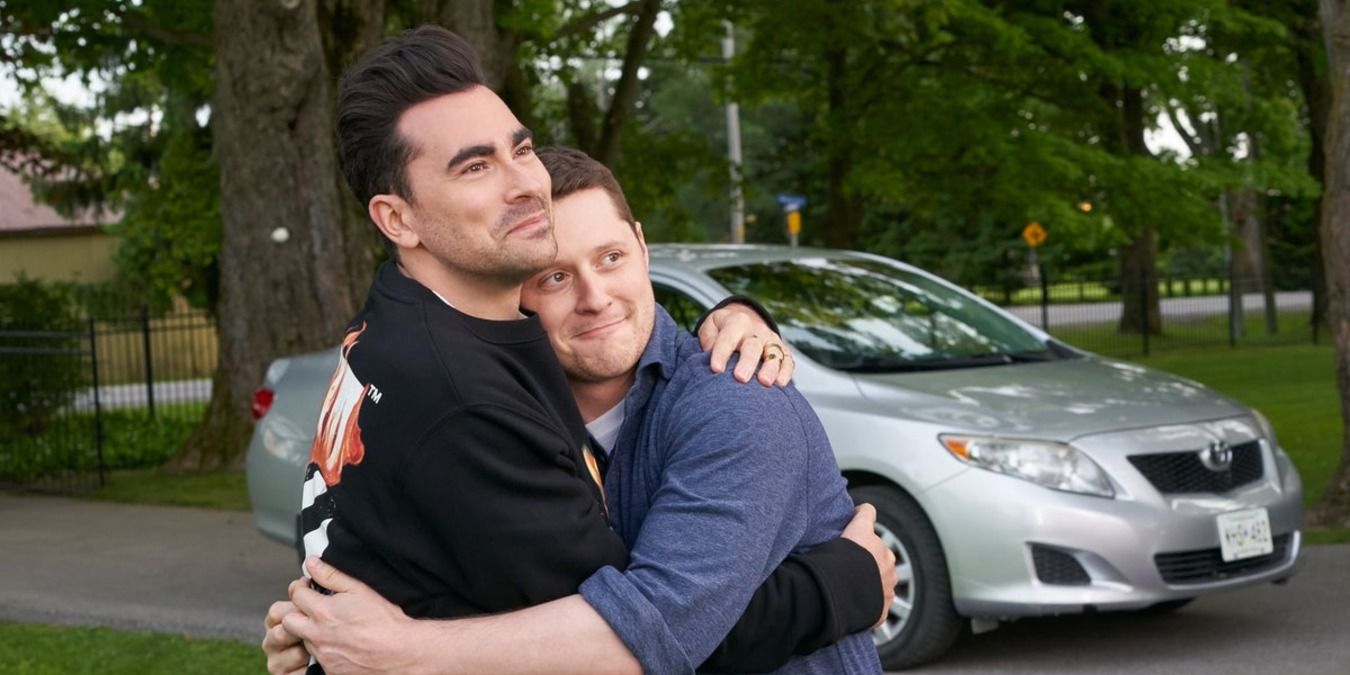 David and Patrick hugging outside and smiling in Schitt's Creek
