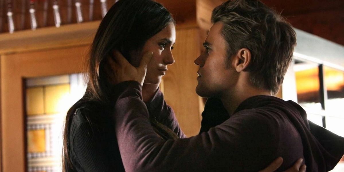 Stefan holds Elena's face before kiss in The Vampire Diaries