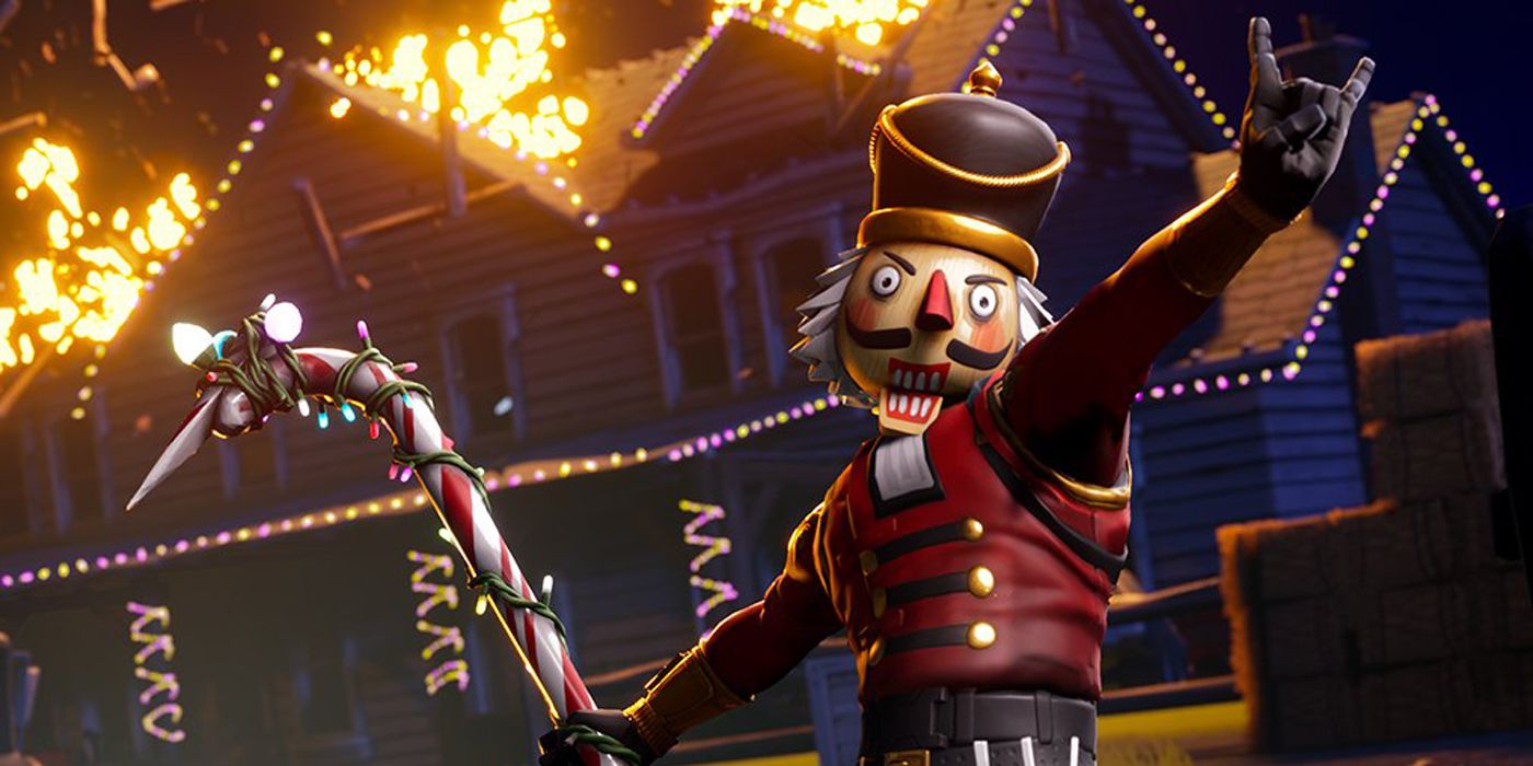 A Fortnite player in the Nutcracker skin is excited by a house burning down