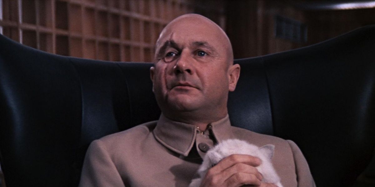 Blofeld holding his white cat while sitting in chair in You Only Live Twice
