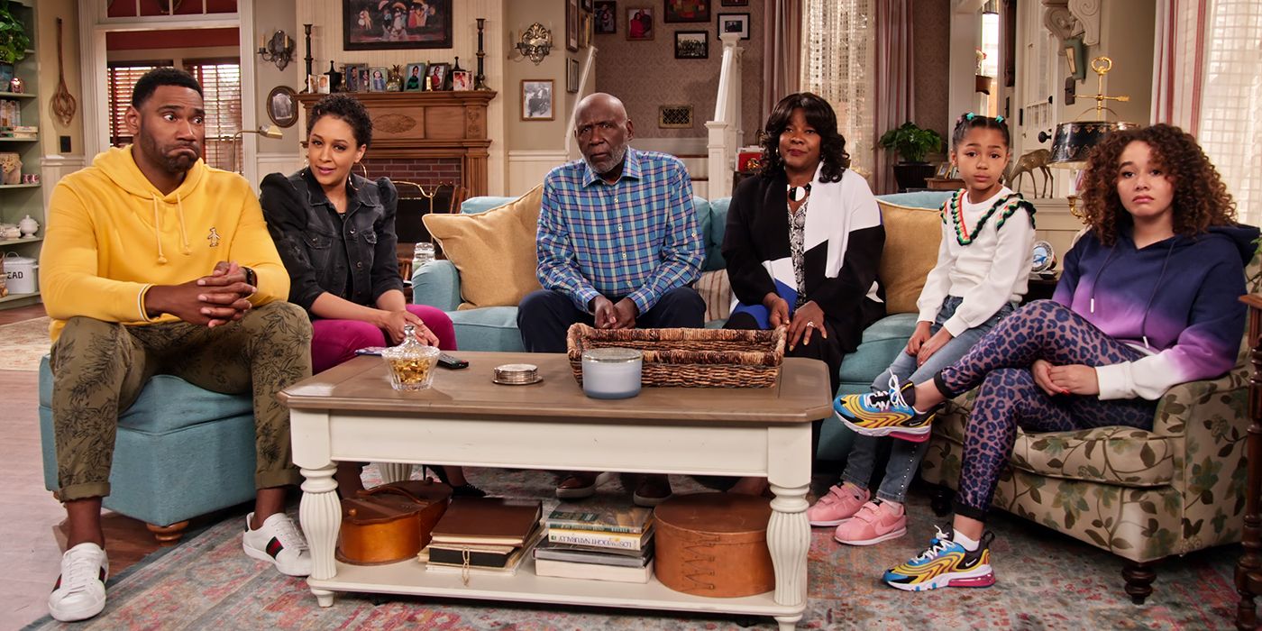 The cast of Family Reunion sitting in a living room